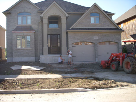 Our Boss previously met with the clients, went over with them what they had wanted and from there came up with a design that best suited what they were envisioning. Here, Albert (our boss) is going over the layout of the plan with Richard, the plan consists of natural stone steps that are going to be built up alongside armour stone that will comfortably lead you to the interlocked driveway. 
